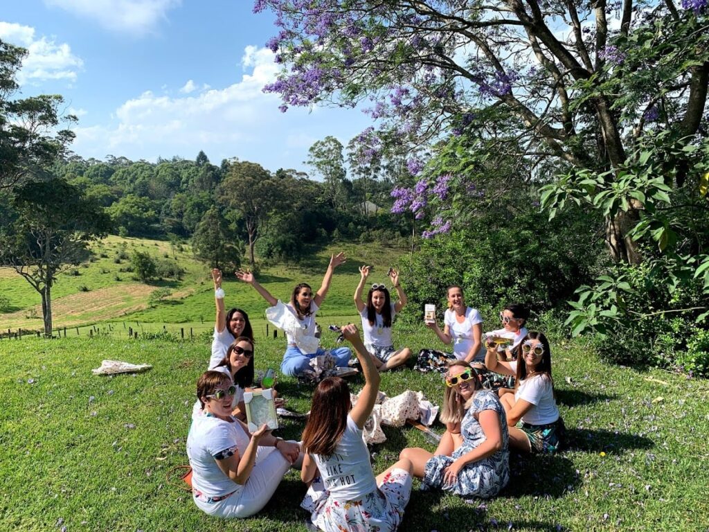 ladies enjoying their hens  party while sitting on the grass