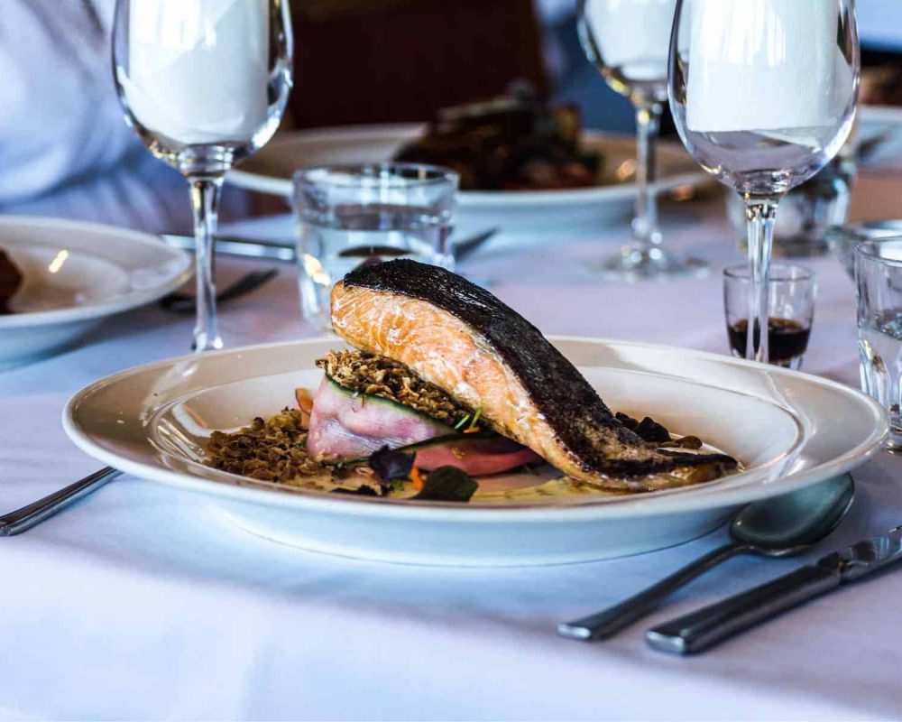 a fresh salmon served at the table