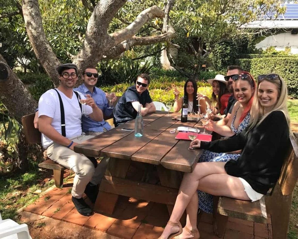 people enjoying their drink under the tree