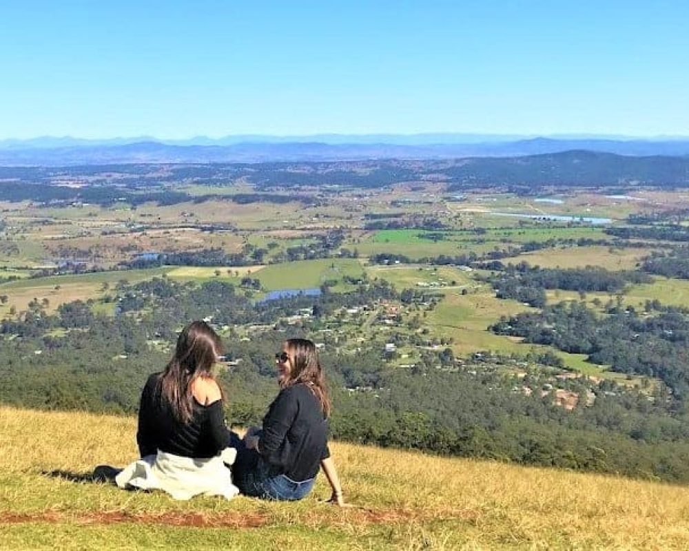 two ladies in black is at the top of mount tamborine